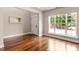 Sun-filled living room boasting hardwood floors, neutral paint, and a large window offering plenty of natural light at 7414 Brandon Allen Ave, Raleigh, NC 27613
