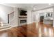 Open-concept living area with a modern fireplace, hardwood floors, and seamless access to the kitchen and dining area at 7414 Brandon Allen Ave, Raleigh, NC 27613