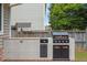 Backyard featuring a built-in grill with tile surround and outdoor countertop at 7414 Brandon Allen Ave, Raleigh, NC 27613
