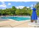 Large pool with lanes for swimming, blue umbrellas, and lounge chairs for relaxation and enjoyment at 7414 Brandon Allen Ave, Raleigh, NC 27613