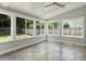 Sunroom with many windows provides ample natural light and backyard views at 7414 Brandon Allen Ave, Raleigh, NC 27613