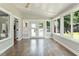 Bright sunroom featuring tile flooring, large windows, and access to the backyard deck at 7414 Brandon Allen Ave, Raleigh, NC 27613