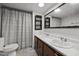 Bathroom featuring double sinks, ample lighting, and a shower/tub combo at 7595 Clayton Blvd # B, Clayton, NC 27520