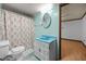 Cozy bathroom with a leaf-patterned shower curtain, blue sink and starfish-themed rug at 7595 Clayton Blvd # B, Clayton, NC 27520