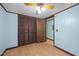 Bedroom with ceiling fan, wood-look floors, and closet at 7595 Clayton Blvd # B, Clayton, NC 27520