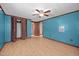 Bedroom with wood-look floors, closet, and bright blue walls at 7595 Clayton Blvd # B, Clayton, NC 27520