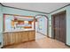 Open kitchen view showcasing the breakfast bar, appliances, tile flooring, and warm wood trim at 7595 Clayton Blvd # B, Clayton, NC 27520