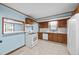 Bright kitchen with tiled floors, wooden cabinets, and modern appliances at 7595 Clayton Blvd # B, Clayton, NC 27520