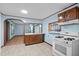 Cozy kitchen featuring tiled floors, an open layout, and essential appliances at 7595 Clayton Blvd # B, Clayton, NC 27520