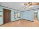 Living room with a door, a window, and light blue walls with wood trim at 7595 Clayton Blvd # B, Clayton, NC 27520