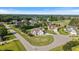 Aerial view showcasing home in a suburban neighborhood with mature trees and well-kept lawns at 8101 Claybrooke Ct, Willow Springs, NC 27592