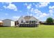 Backyard featuring a well-maintained lawn, above ground pool, and white siding of house at 8101 Claybrooke Ct, Willow Springs, NC 27592
