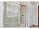 Bathroom shower with glass doors and stone surround, plus white door at 8101 Claybrooke Ct, Willow Springs, NC 27592
