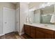 Bright bathroom with double vanity, wood cabinets, shower with glass doors and decorative tile surround at 8101 Claybrooke Ct, Willow Springs, NC 27592