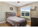 Bedroom featuring a queen size bed, side table, dresser, and large window for plenty of light at 8101 Claybrooke Ct, Willow Springs, NC 27592