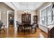 Elegant dining room featuring hardwood floors, large windows, and stylish chandelier at 8101 Claybrooke Ct, Willow Springs, NC 27592
