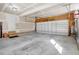 Spacious garage with a roll up door, concrete flooring, and a clean, organized space at 8101 Claybrooke Ct, Willow Springs, NC 27592