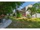 Serene backyard with mature trees, white fence, a cozy screened porch, and a relaxing patio seating area at 8205 Rolling Glenn Dr, Raleigh, NC 27616