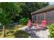 Outdoor living area featuring a paved patio with comfortable seating, perfect for relaxing in the backyard at 8205 Rolling Glenn Dr, Raleigh, NC 27616
