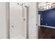 Bright bathroom featuring a shower with a chrome shower head and white walls at 8205 Rolling Glenn Dr, Raleigh, NC 27616