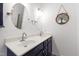 Bathroom featuring a double sink vanity, white countertops, and modern decor at 8205 Rolling Glenn Dr, Raleigh, NC 27616