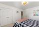 Bright bedroom showcasing a black and white checkered bedspread and neutral walls at 8205 Rolling Glenn Dr, Raleigh, NC 27616