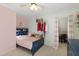 Colorful ' bedroom featuring pink and green walls, and a ceiling fan at 8205 Rolling Glenn Dr, Raleigh, NC 27616