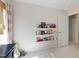 Bright bedroom featuring a book collection displayed on floating shelves and a neutral carpet at 8205 Rolling Glenn Dr, Raleigh, NC 27616