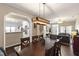 Open-concept dining area boasts wooden table, seating for eight, and stylish light fixture at 8205 Rolling Glenn Dr, Raleigh, NC 27616