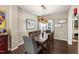 Bright dining room featuring wooden table, eight chairs, wooden light fixture and hardwood flooring at 8205 Rolling Glenn Dr, Raleigh, NC 27616