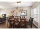 Open dining area with wooden table, eight chairs, and unique wooden light fixture at 8205 Rolling Glenn Dr, Raleigh, NC 27616