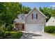 Charming home featuring a two-car garage, stone porch accents, and well-maintained landscaping at 8205 Rolling Glenn Dr, Raleigh, NC 27616
