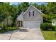 Charming home featuring a two-car garage, stone porch accents, and well-maintained landscaping at 8205 Rolling Glenn Dr, Raleigh, NC 27616