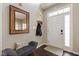 Inviting foyer with coat rack, mirror, bench and neutral decor at 8205 Rolling Glenn Dr, Raleigh, NC 27616