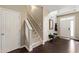 Inviting foyer with coat rack, mirror, bench and neutral decor at 8205 Rolling Glenn Dr, Raleigh, NC 27616
