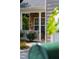 Inviting front porch with stone accents, classic columns, and a charming, well-maintained landscape at 8205 Rolling Glenn Dr, Raleigh, NC 27616