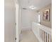 Hallway featuring white walls, neutral carpet, and access to bedrooms and bathrooms at 8205 Rolling Glenn Dr, Raleigh, NC 27616