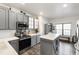 Well-lit kitchen with grey cabinets, stainless steel oven and microwave, and white subway tile backsplash at 8205 Rolling Glenn Dr, Raleigh, NC 27616