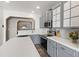 Bright kitchen featuring grey cabinets, stainless steel appliances, and white countertops at 8205 Rolling Glenn Dr, Raleigh, NC 27616