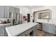 Contemporary kitchen featuring grey cabinetry, center island, stainless steel appliances, and stylish backsplash at 8205 Rolling Glenn Dr, Raleigh, NC 27616