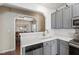 Modern kitchen with white countertops, grey cabinets, subway tile backsplash, and stainless steel appliances at 8205 Rolling Glenn Dr, Raleigh, NC 27616