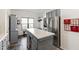 Functional kitchen with grey cabinets, kitchen island and stainless steel refrigerator at 8205 Rolling Glenn Dr, Raleigh, NC 27616