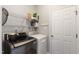 Functional laundry room with a front-load washer and dryer, shelving, and a white door at 8205 Rolling Glenn Dr, Raleigh, NC 27616