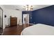 Spacious bedroom with dark wood flooring, a ceiling fan, and plenty of natural light at 8205 Rolling Glenn Dr, Raleigh, NC 27616