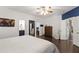 Bright bedroom featuring dark wood flooring, large windows, and ensuite bathroom access at 8205 Rolling Glenn Dr, Raleigh, NC 27616