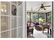View of cozy screened-in porch with wicker furniture, a ceiling fan, and views of backyard at 8205 Rolling Glenn Dr, Raleigh, NC 27616