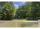 Backyard view from a porch featuring a lush green lawn with playground and mature trees offering shade and privacy at 860 Cokesbury Rd, Fuquay Varina, NC 27526