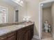 Bathroom featuring granite countertops, dark wood cabinets, and tiled floors at 860 Cokesbury Rd, Fuquay Varina, NC 27526