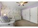 Charming Bedroom with floral wallpaper, white crib, and cozy glider chair at 860 Cokesbury Rd, Fuquay Varina, NC 27526