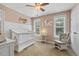 Bright Bedroom with a white crib, glider chair, and natural light at 860 Cokesbury Rd, Fuquay Varina, NC 27526